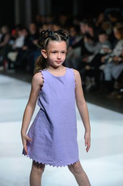 Toronto, ON, Kanada - 7 Aralık 2024: Toronto Çocuk Moda Haftası 'nda Little Olin koleksiyonunda bir model podyumda yürüyor.