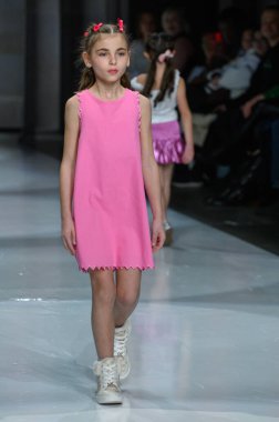 Toronto, ON, Kanada - 7 Aralık 2024: Toronto Çocuk Moda Haftası 'nda Little Olin koleksiyonunda bir model podyumda yürüyor.