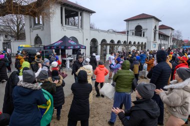 Toronto, ON, Canada  January 1, 2025: Many people gathered to take part in the Toronto Polar Bear Dip organization.. clipart