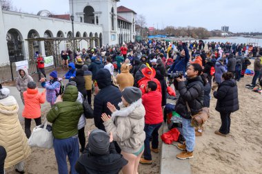 Toronto, ON, Canada  January 1, 2025: Many people gathered to take part in the Toronto Polar Bear Dip organization.. clipart