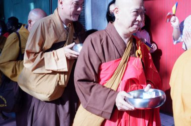 the buddist priest is being a procession of worship, prosesi thudong, biksu bante budha berjalan kaki, dari thailand ke candi borobudur di Indoneisa, hari waisak, nampak para biksu berjalan membawa wadah menerima sumbangan dari orang lain