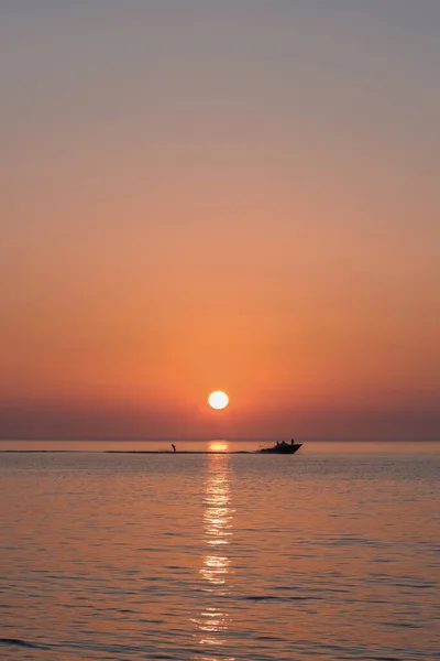 Stock image Picturesque view of beautiful sunset with a boat pulling a person behind