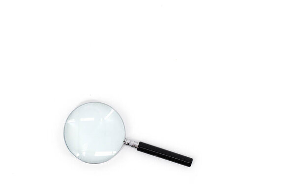 An image of a magnifying glass with a black handle and a silver rim around the magnifying glass, set against a pristine white backdrop.