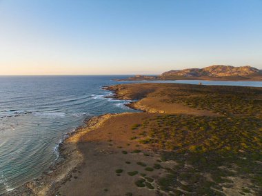 Isola Piana 'nın, Sassari, Sardunya' daki La Pelosa Sahili yakınlarındaki hava görüntüsü. Savunma ve iletişim kulesi Torre di Punta Imbarcatogio 'nun iyi korunmuş kalıntıları..