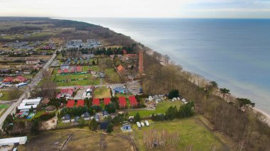 İHA görüntülerinde Gaski sahili, Batı Pomeranya Voyvoda 'sı, kırmızı tuğlalı deniz feneri, Baltık Denizi, kumlu sahil, yapraksız kum ağaçları, tatil kulübeleri, oteller ve evler yer alıyor. Muhtemelen sakin bir deniz. Şubat ayında yakalandı..