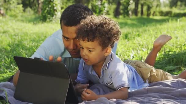 Multiethnic Father Son Drawing App Tablet Have Fun Lying Outdoor — Stock Video