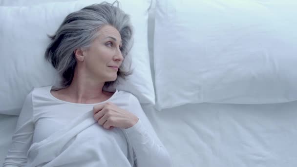 Pretty Senior Woman Stroking Pillow Lying Bed Thinking Husband Breakup — Stock Video