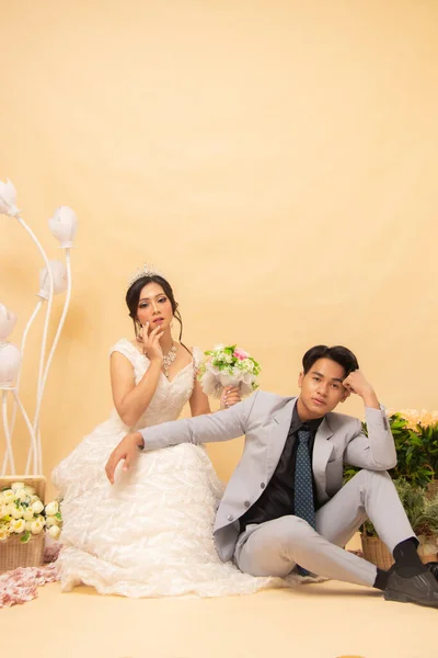 expressions of male and female couples sitting relaxed smiling at each other looking forward intimately indoor photo shot. couple wedding national bride studio