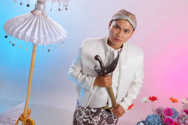 stock image handsome young Asian man standing elegantly sharp wearing modern Javanese traditional clothing, white velvet bridal kebaya on a white studio background. for advertising content, beauty, fashion