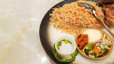 Kebuli rice (nasi kebuli) closeup, typical Arabic food on the table with empty space beside it, top angle detail clipart