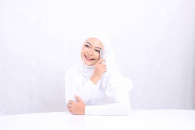 Dudak makyajının yakın çekimi Endonezya 'nın güzel yetişkin kadın başörtüsü mutlu görünüyor sağ üst el ruj izi sol yüz izole beyaz arka plan. Kozmetik reklam konsepti, dudak rengi, ruj modeli