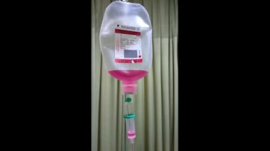 Hasta ve infüzyon pompası için hastane koğuşunda odası ve ışık geçmişi olan serum fizyolojik solüsyon serumunu kapatın. Sağlık, eğitim ve bilim içeriği için