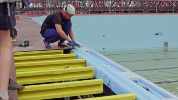 Man Helmet Measures Tile Size Swimming Pool Edge Construction Site — Stock Video