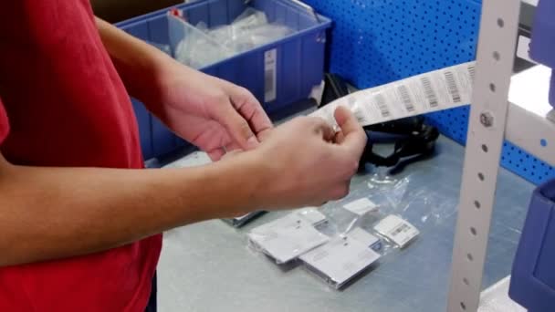 Male Warehouse Worker Work Uniform Removes Stickers Paper Sticks Consumer — Stock Video