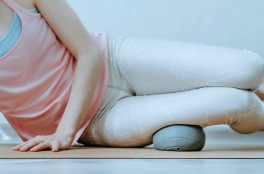 Bilişim bandı nazik fasya salınımını büyük yumuşak bir masaj topuyla yapan kişiye yaklaş. Konsept: spor öncesi ısınma, diz ağrısı rahatlama