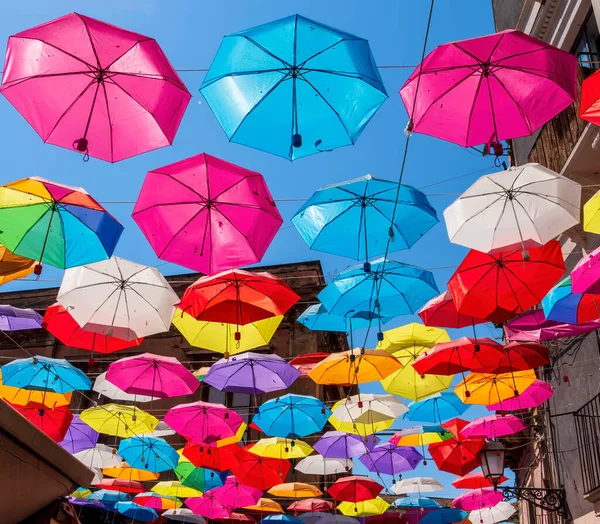 Colorful umbrellas background. Colorful rainbow umbrellas in the sky. Street decoration.