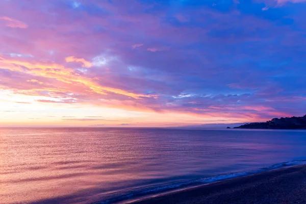 stock image view at sunrise or sunset in sea with nice beach , surf , calm water and beautiful clouds on a background of a sea landscape