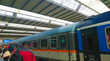 Münih Hauptbahnhof, Münih, Almanya - 17 Haziran 2018: Münih ana tren istasyonunda trenle platformlarda yürüyen yolcular