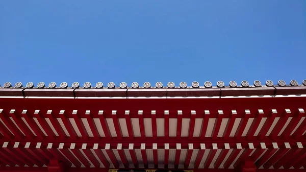 stock image Tokyo, Japan - 10.30.2019: Close-up view of the Senso-ji tiled roof under a blue clear sky before the pandemic on a sunny day