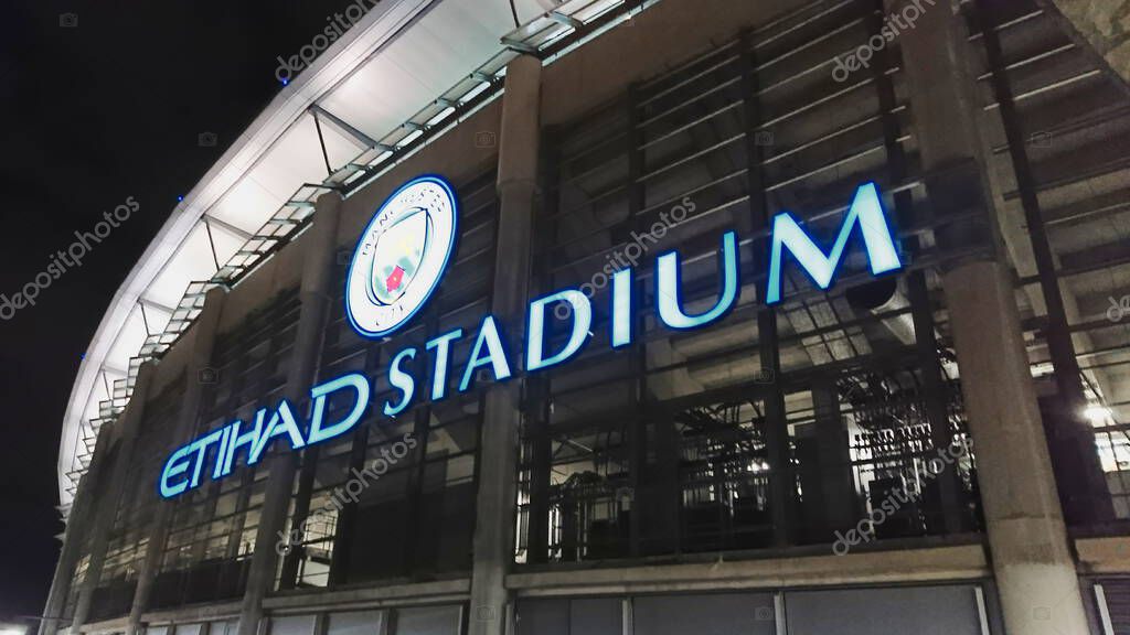 Etihad Stadium, Manchester, United Kingdom - March 7, 2018: Illuminated sign of the Etihad Stadium on the exterior of the stadium at night