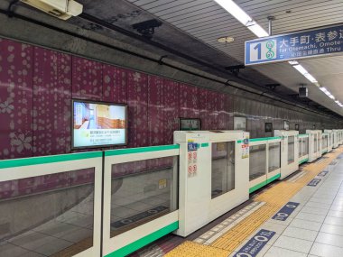 Tokyo, Japonya - 08.06.2024: Sendagi İstasyonu 'ndaki Tokyo Metro Chiyoda Hattı peronu kapalı platform kapıları ve platformun kenarında yolcu ve reklamlar olmadan asfalt döşemesi