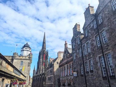 Edinburgh, İngiltere - 16 Temmuz 2025: The Hub 'ın ikonik Gotik kulesi, UNESCO' nun Dünya Mirası Alanındaki Edinburg Eski Kasabası 'ndaki Royal Mile' daki tarihi taş binaların üzerinde yükseliyor.