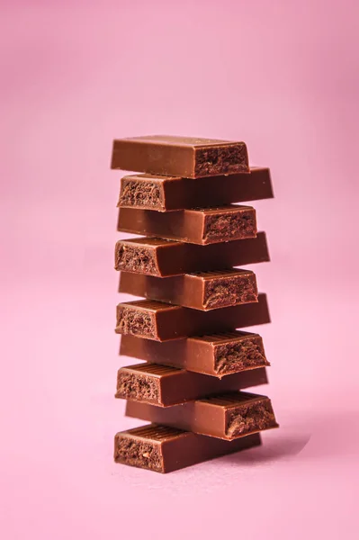 stock image chocolate pieces on pink background