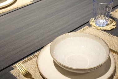 Güzel masa boş beyaz tabak bıçağı ve çatalı gri masanın üzerine koyuyor.