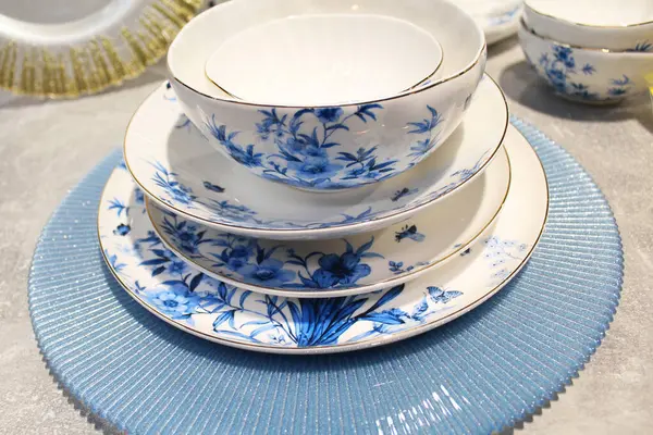 blue ceramic plates, porcelain plates and cups on a table