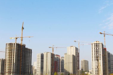 Mavi gökyüzünün altında inşaat vinci ve bina, şehirde yeni apartmanlar