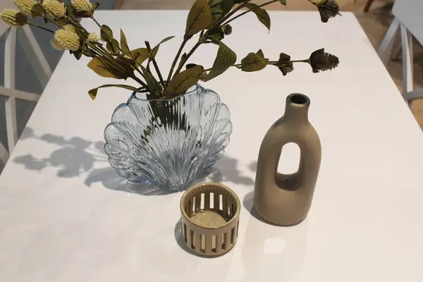 Tahta masadaki beyaz vazo.