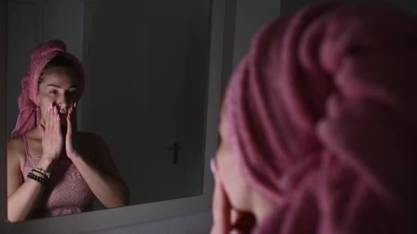 Woman Pink Top Pink Towel Her Head Stands Front Mirror — Stock Video