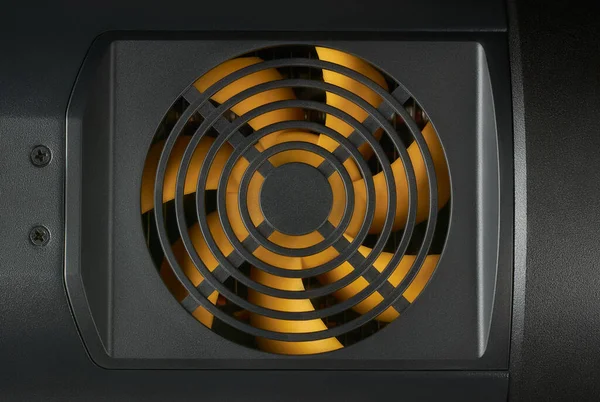close-up of cooling fan with yellow plastic blades, cooling computers and other electronic equipments with a black background, copy space