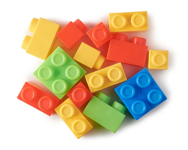 different shapes of toy blocks, aka building blocks, interlocking plastic bricks powerful learning tools baby and kids, scattered on white background