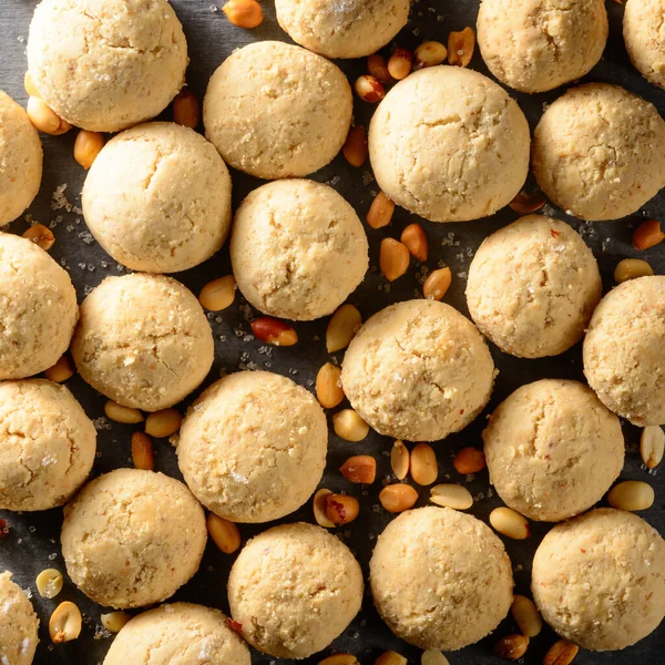peanut butter cookies, consist of natural peanut butter, flour and sugar, closeup view of baked sweet biscuits with scattered peanuts, food background