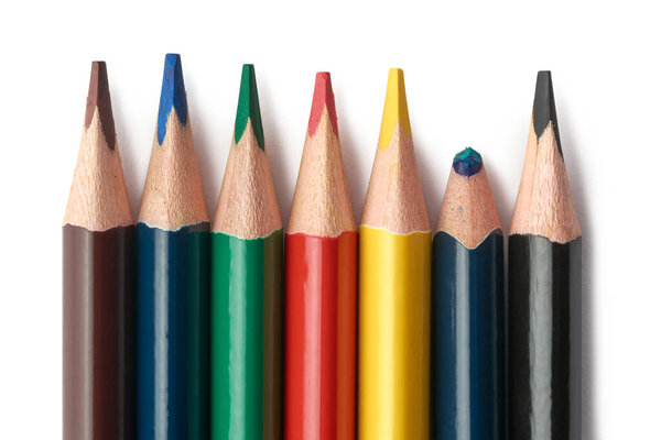 bunch of sharpened color pencils, used one with unused pencils isolated on white background