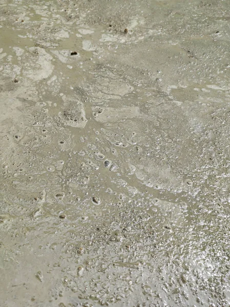 close-up of too wet concrete surface, watery cement mixture, prone to crack, weak and failure, selective focus