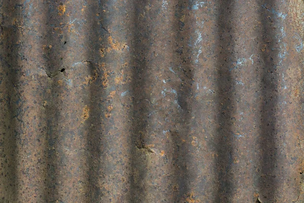 aged and rusty corrugated metal roofing sheet background texture, old rustic, weathered roof surface backdrop for photography, closeup view