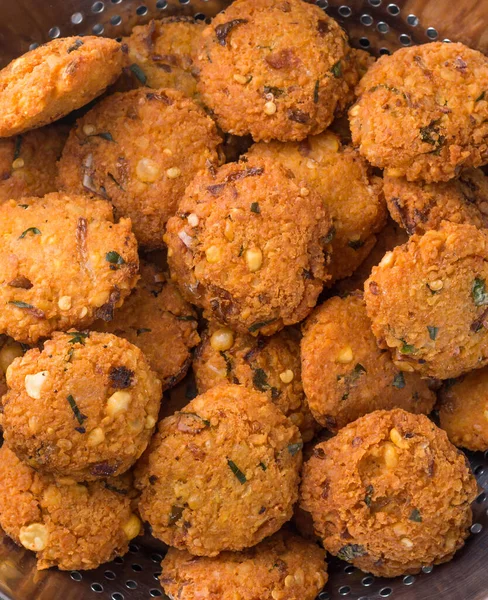 lentil fritters, savoury fried snack also called dal vada, wada or vadai in south east asia, deep fried vegetarian food
