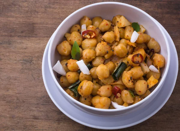 stock image cooked chickpeas or grams dish, also known as garbanzo beans or egyptian peas boiled and tempered with oil and coconut, healthy vegetarian dish