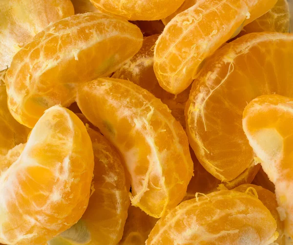 tangerines, fresh mandarin orange slices or pieces, citrus fruit background, closeup macro