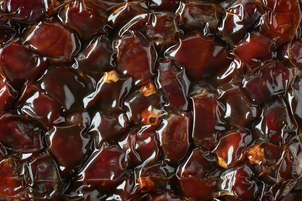 close-up of dates in vacuum sealed packs, edible and tropical sweet fruits in thermoforming packaging in flexible film full frame sweet food background