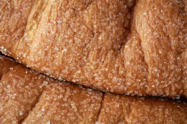 Taze pişmiş şeker kaplı çörekler, serpiştirilmiş şeker ve tonlama yüzeyinin makro görüntüsü, üst görünüm tam çerçeve yiyecek arka planı.