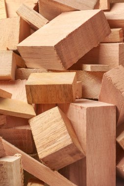 close-up of wood scraps or offcuts, many shapes and sizes leftover blocks or pieces of wood from various woodworking projects, soft focus and blurry background clipart