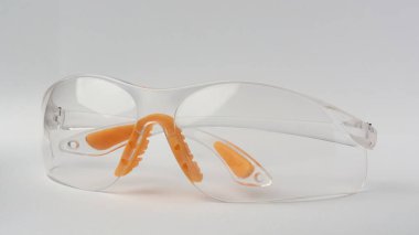 safety goggles with clear lens isolated gray background, eyewear designed shield eyes from dust, chemicals and flying debris or particles used in laboratory and workshop clipart