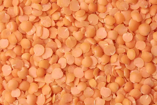 Kırmızı mercimek ya da mazoor dalın tam kapasite yemek arka planında yakın çekim makro görüntüsü, Hint, Orta Doğu ve Güney Asya mutfağı için malzeme yığını