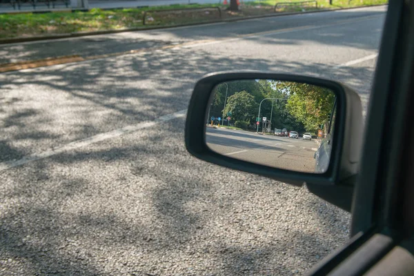 milan, italy, 11 September 2023,car traffic seen in a rearview mirror of a car. , traffic control with artificial intelligence will soon arrive to reduce accidents.