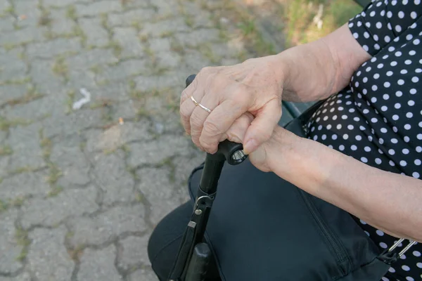 elderly person with cane, leg support with the cane useful for walking in the park, walking problems, arthrosis.