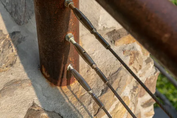 stock image detail of the stainless steel rope railing offers safety and modern design, while the corten steel structure ensures resistance to atmospheric agents. combination for durability and elegance, in use for contemporary architectural space projects.