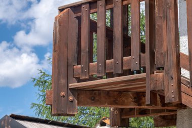 Karakteristik bir dağ evinin ön cephesi boyunca sert ahşap kirişler ve korkuluklarla kaplı dış ahşap merdiven rüzgarları, kırsal Alp binasının güzelliğini artırıyor..